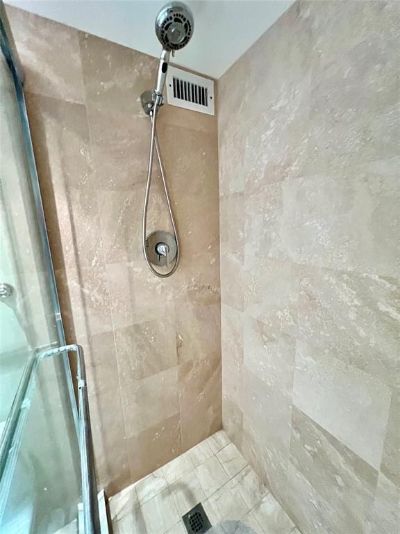 bathroom with a tile shower