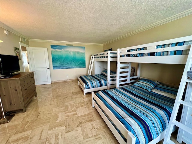 bedroom featuring crown molding, light parquet floors, and a textured ceiling