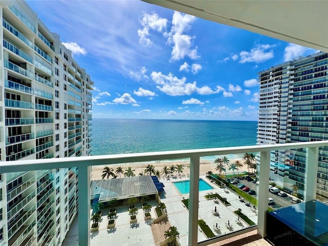 balcony with a water view and a beach view