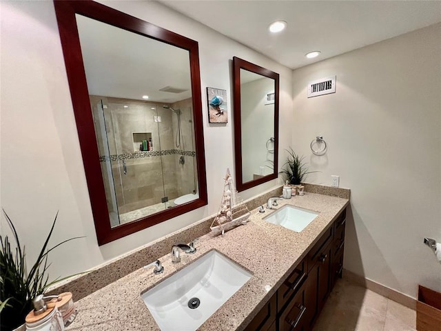 bathroom with tile patterned flooring, vanity, and a shower with shower door