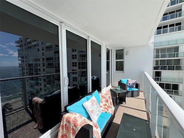 balcony featuring a water view and an outdoor hangout area