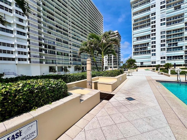 surrounding community with a patio and a pool