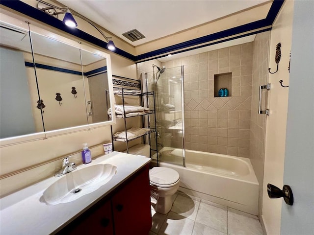 full bathroom with tile patterned floors, vanity, tiled shower / bath combo, and toilet