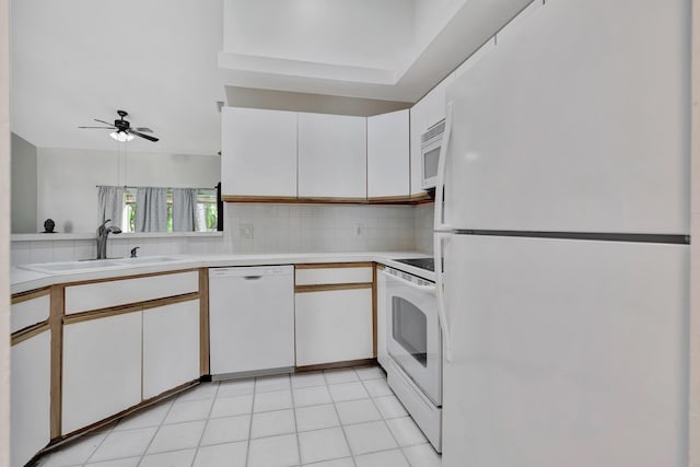 kitchen featuring sink, light tile patterned floors, white cabinets, white appliances, and backsplash