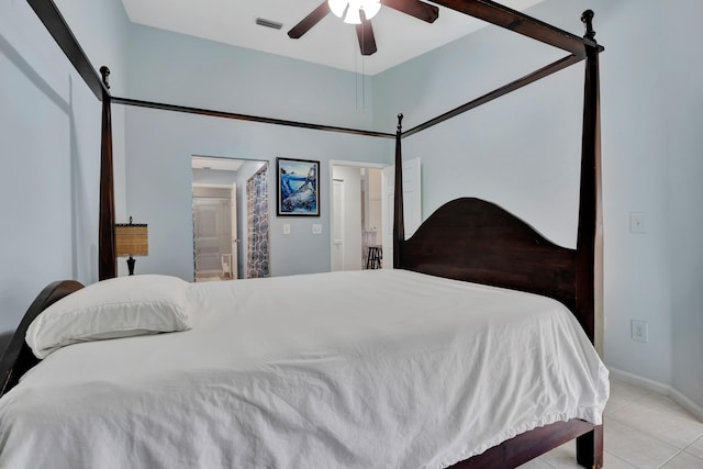 tiled bedroom with ceiling fan and ensuite bath