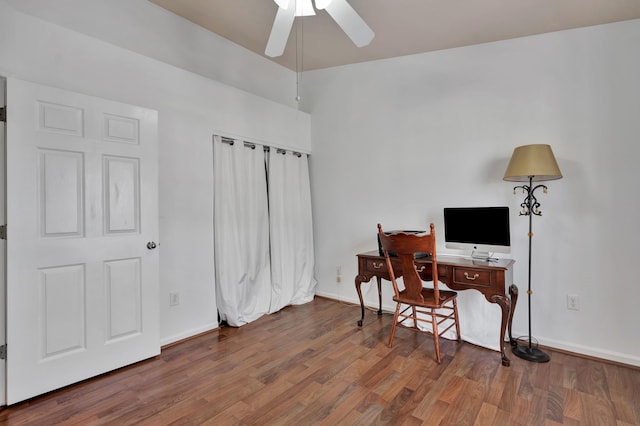 office area with ceiling fan, baseboards, and wood finished floors
