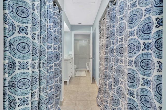 bathroom with tile patterned flooring, vanity, and toilet