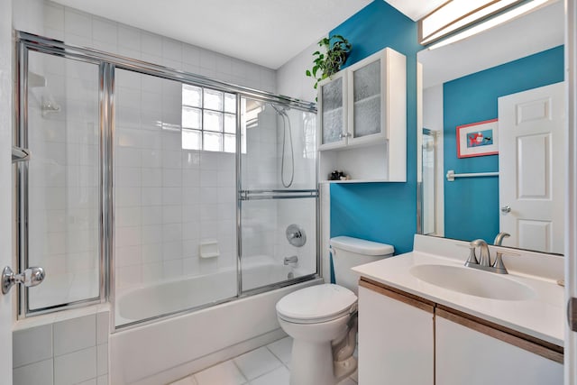 full bath with toilet, enclosed tub / shower combo, tile patterned flooring, and vanity