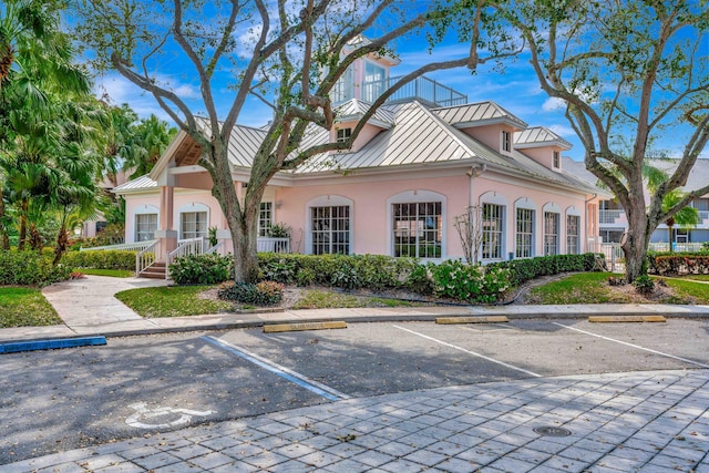 202 Muirfield Ct Unit E, Jupiter, FL 33458 - view of building exterior featuring uncovered parking