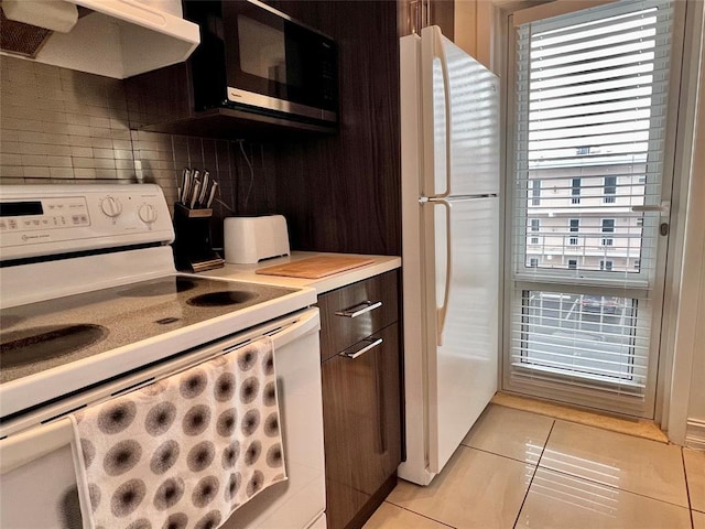 kitchen with ventilation hood, backsplash, plenty of natural light, white appliances, and light tile patterned floors