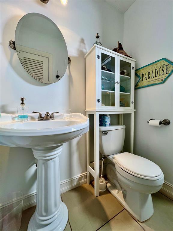 bathroom featuring tile patterned floors, sink, and toilet