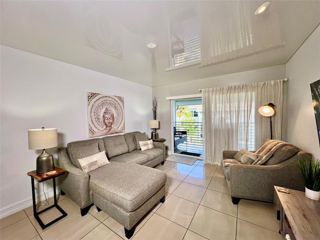 tiled living room featuring a towering ceiling