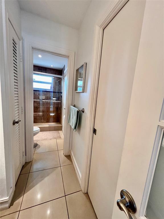 hallway featuring light tile patterned flooring