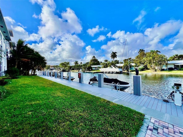 view of dock featuring a lawn and a water view