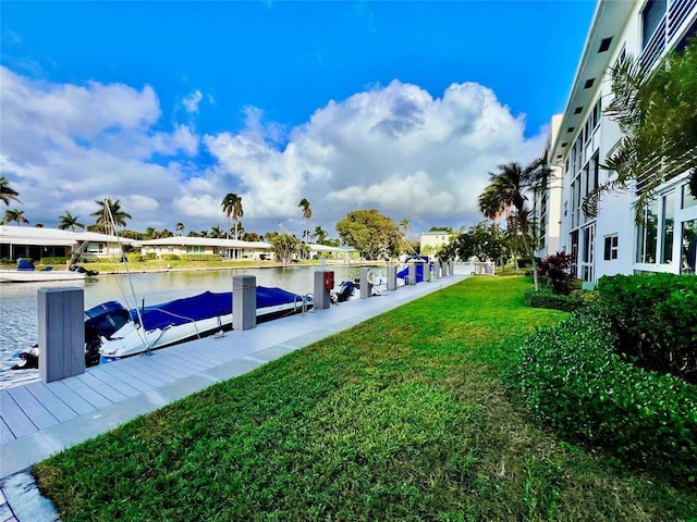 dock area with a water view and a lawn