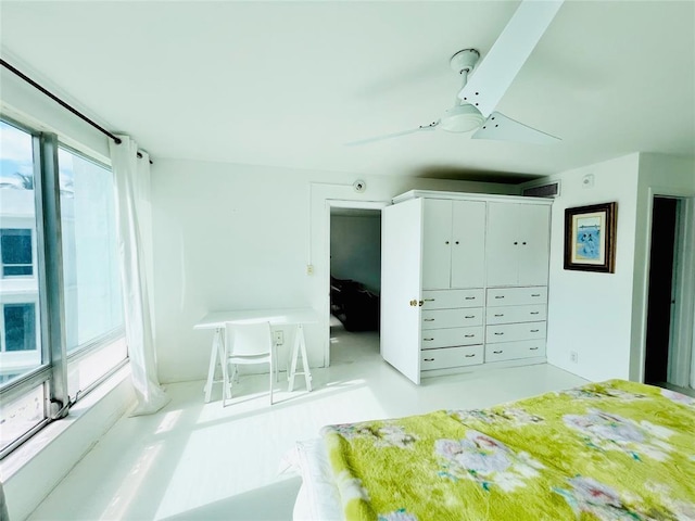 unfurnished bedroom featuring ceiling fan, a closet, and multiple windows