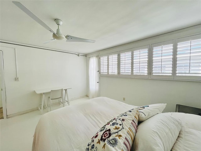 bedroom featuring ceiling fan and light carpet