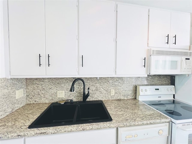 kitchen with white cabinets, white appliances, tasteful backsplash, and sink