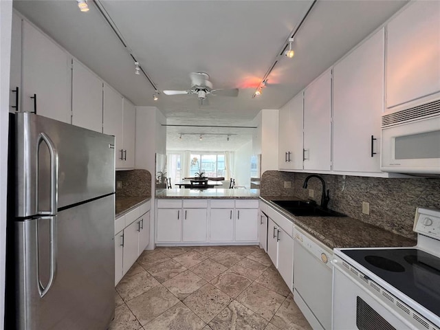 kitchen featuring white cabinetry, sink, track lighting, and white appliances