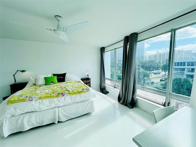 bedroom featuring ceiling fan and concrete flooring