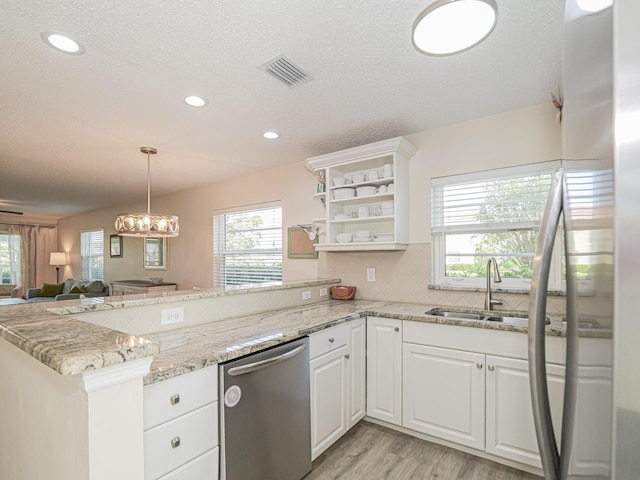 kitchen featuring kitchen peninsula, a textured ceiling, sink, dishwasher, and white cabinetry