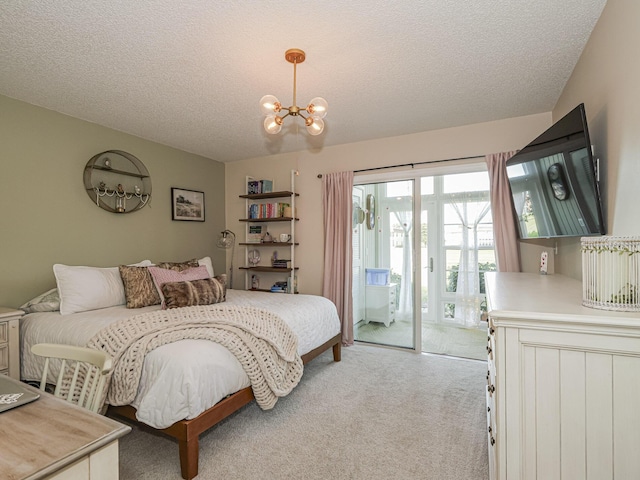 bedroom featuring a notable chandelier, access to exterior, a textured ceiling, and light carpet