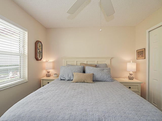 bedroom featuring a textured ceiling and ceiling fan