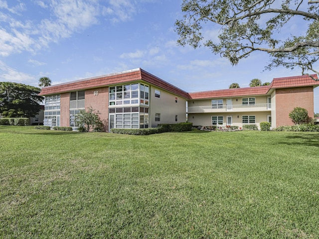 rear view of property with a lawn