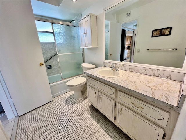 full bathroom with tile patterned flooring, vanity, toilet, and enclosed tub / shower combo