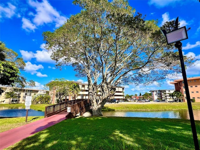 view of home's community with a yard and a water view