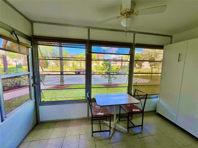 sunroom / solarium featuring ceiling fan