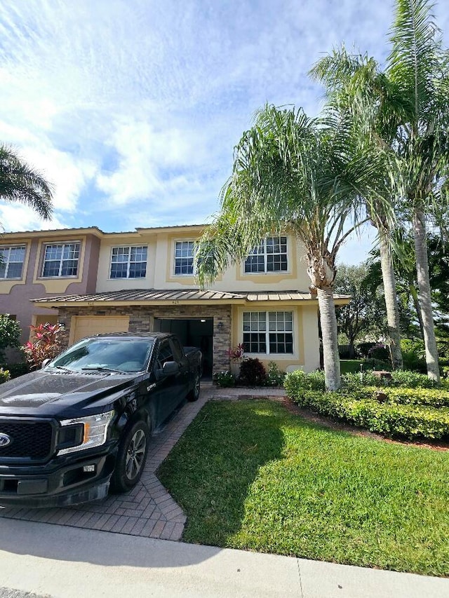 view of front facade with a carport and a front lawn