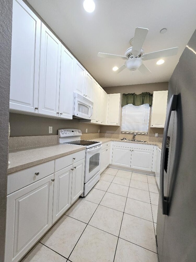 kitchen with ceiling fan, light tile patterned floors, white cabinets, and white appliances