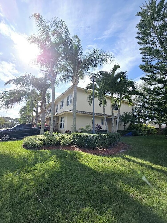 view of side of property with a lawn