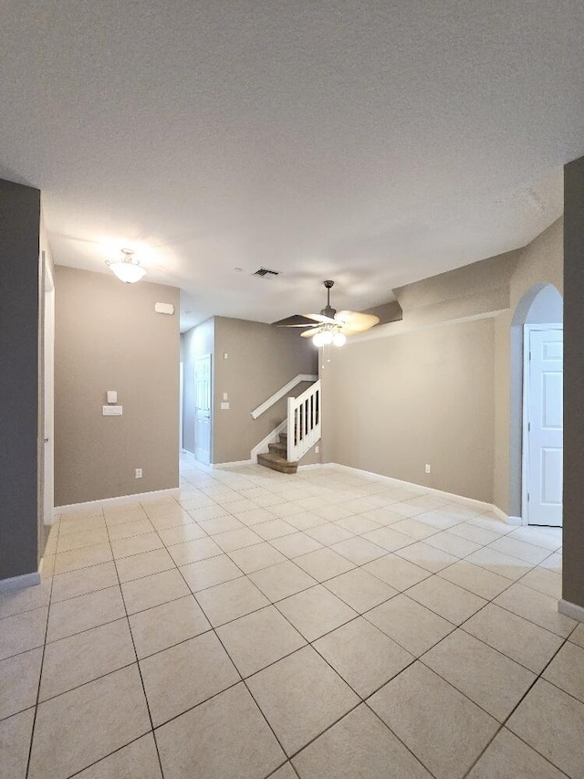 unfurnished room featuring ceiling fan and light tile patterned floors