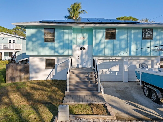 view of front of property featuring a garage and a front yard