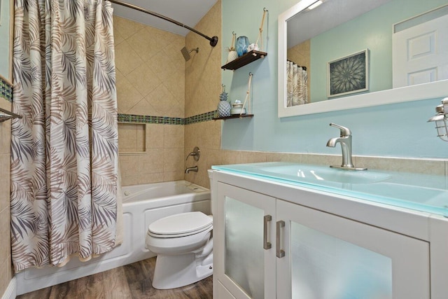 full bathroom with shower / bath combo, toilet, wood-type flooring, and vanity