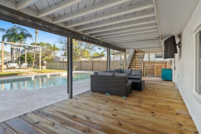 wooden terrace featuring an outdoor living space and a fenced in pool