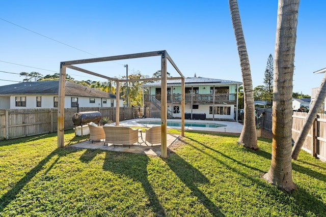 view of yard with a fenced in pool, a patio area, outdoor lounge area, and a balcony