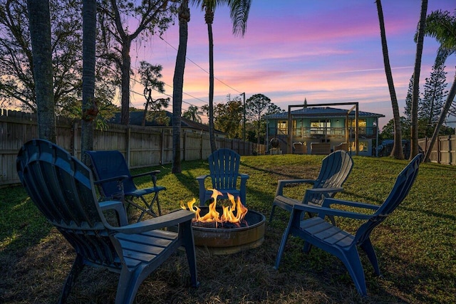 yard at dusk with a fire pit