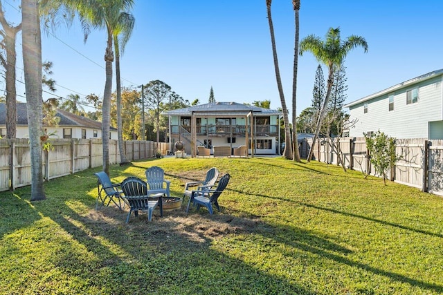 view of yard featuring a balcony and a fire pit