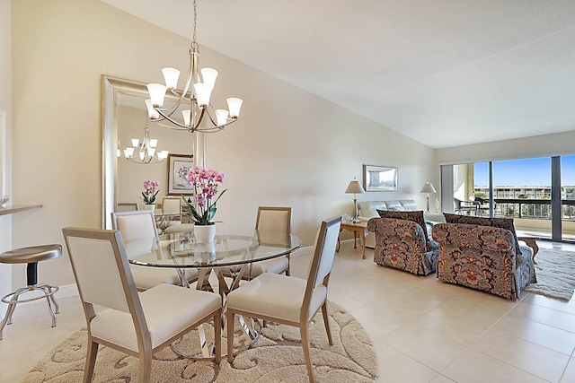 tiled dining space featuring a chandelier and lofted ceiling