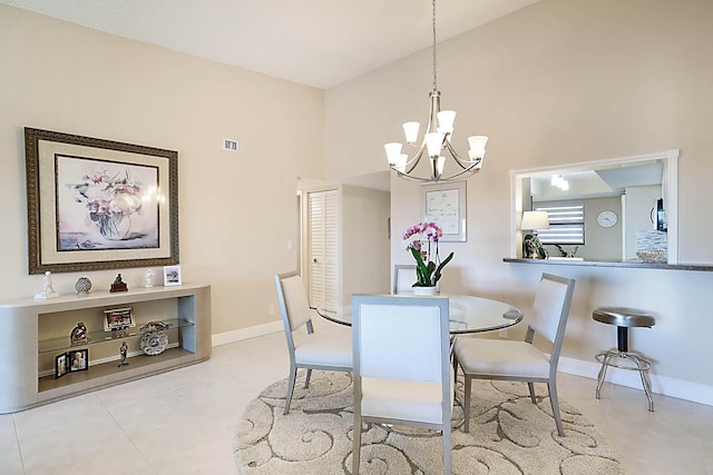 tiled dining space with a towering ceiling and an inviting chandelier