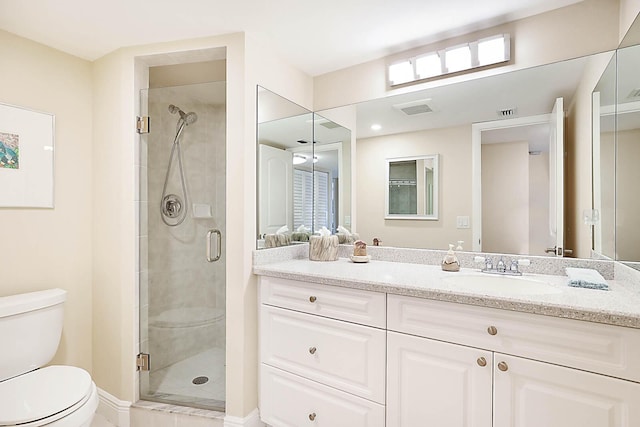 bathroom featuring vanity, toilet, and walk in shower