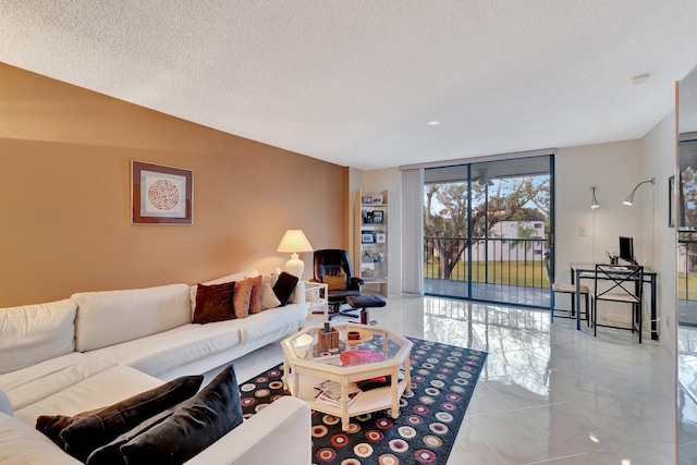 living room featuring floor to ceiling windows and a textured ceiling