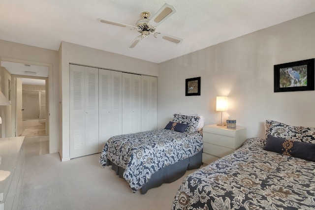 bedroom featuring ceiling fan, light colored carpet, and a closet