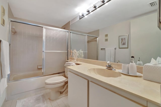 full bathroom featuring toilet, enclosed tub / shower combo, vanity, and tile patterned floors