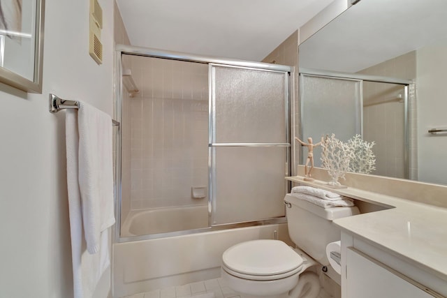 full bathroom with tile patterned floors, bath / shower combo with glass door, toilet, and vanity