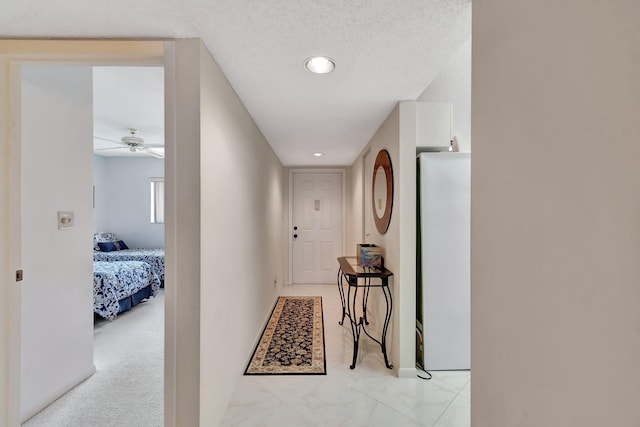 hallway featuring a textured ceiling