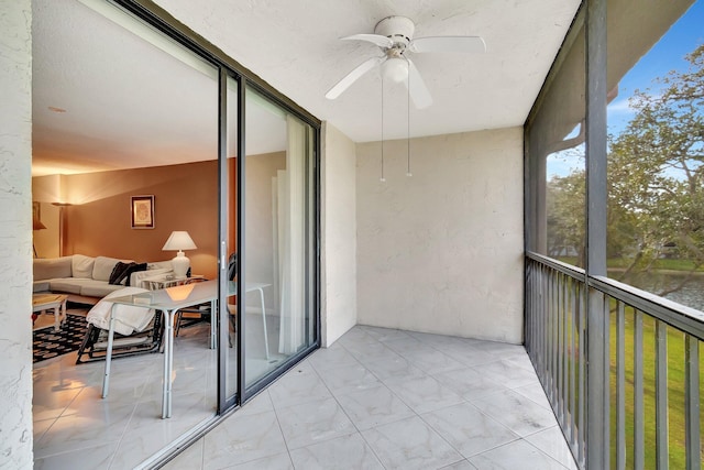 sunroom featuring ceiling fan